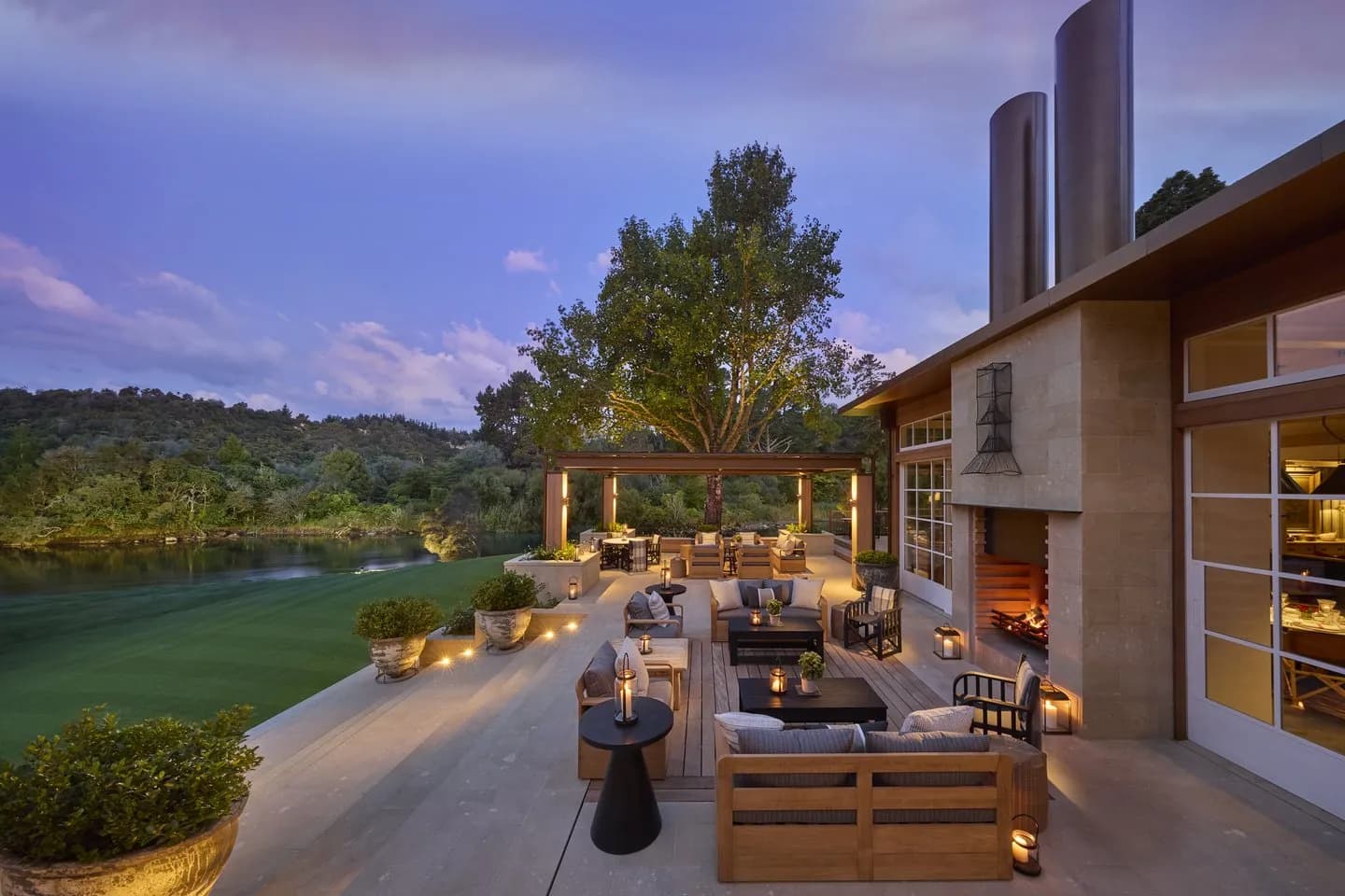 Terrace featuring seating areas, a fire pit, planters, and views of the Waikato River.