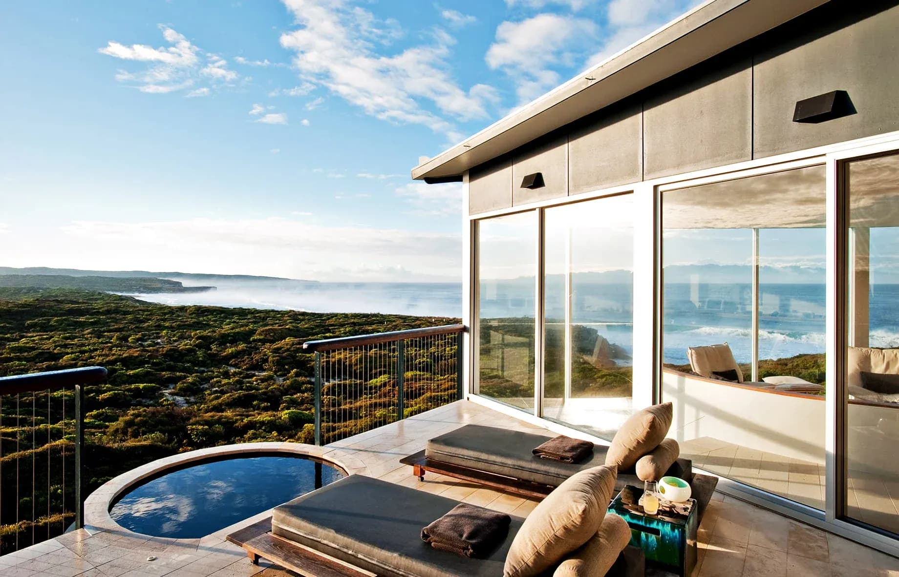 Lounge area featuring two sun loungers, a plunge pool, and expansive ocean views.