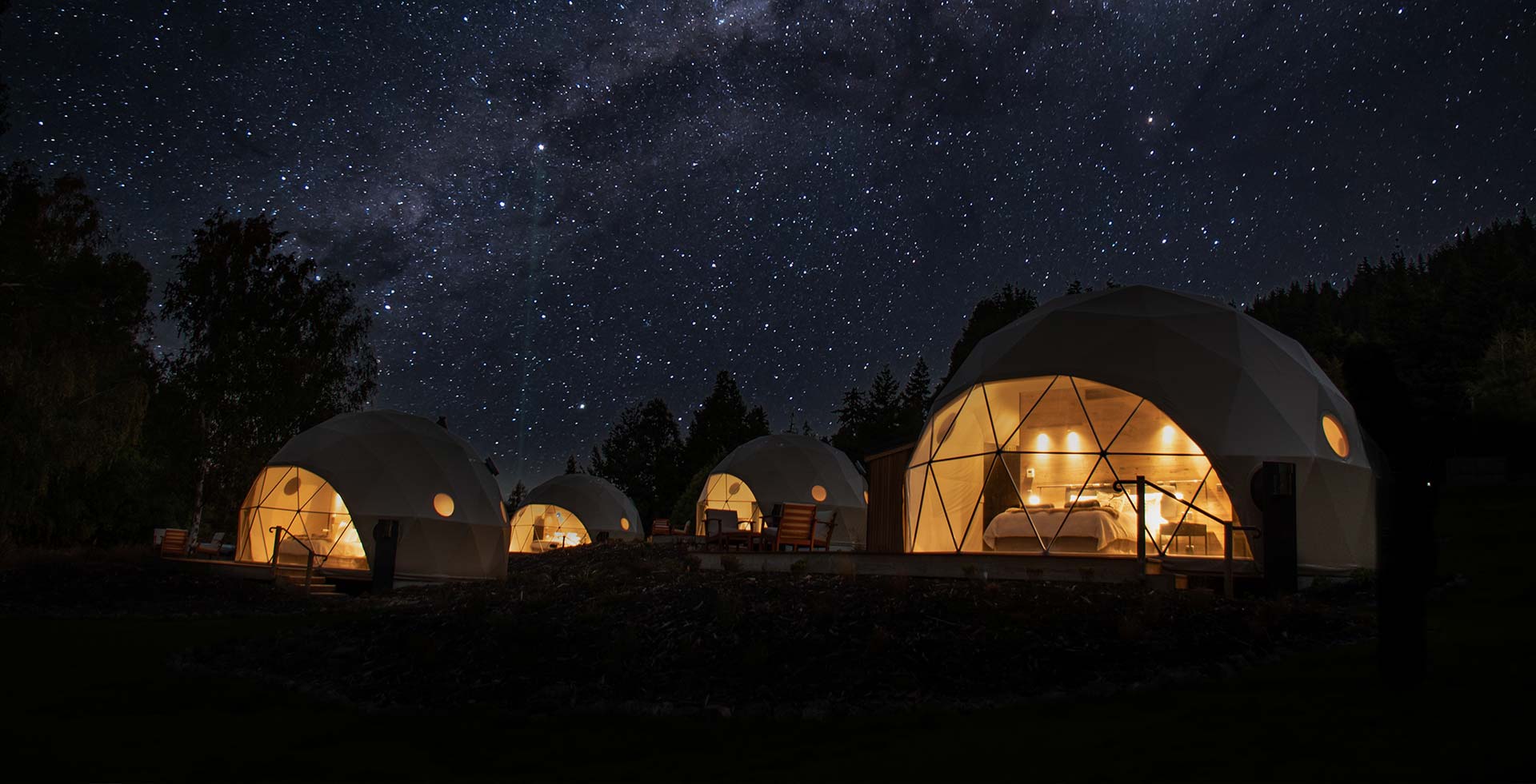 Cross Hill Geo Domes glowing at night beneath a star-filled sky.